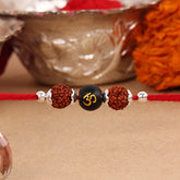 Dual Rudraksha With Black Om Stone Silver Bead Rakhi